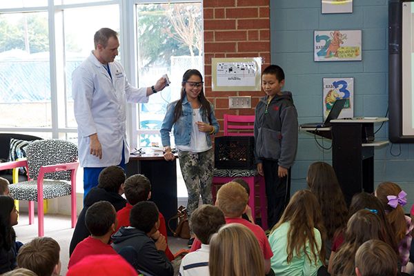 Kids use Dental Tools with Dr. Ernst at Indian Trail Elementary School