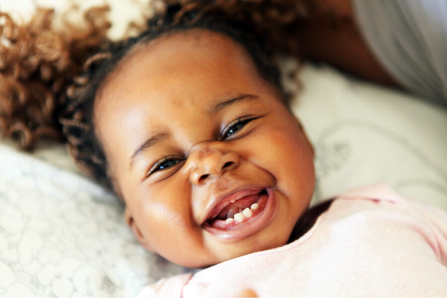 Closeup of a little girl with a few baby teeth before her first dental visit