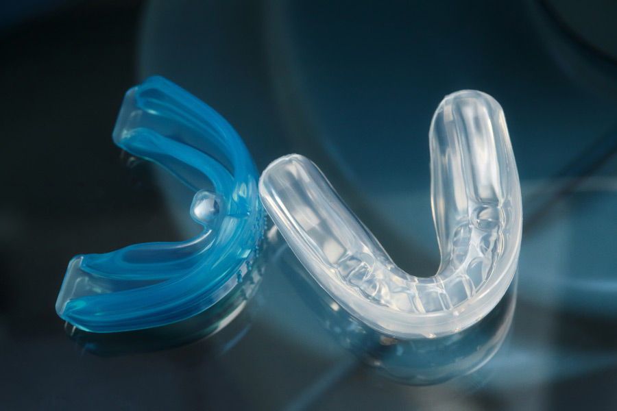 Closeup of blue and clear custom mouthguards at the dentist in Indian Trail, NC