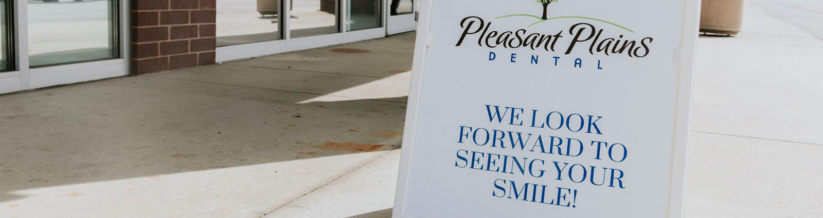 sign that says 'We Look Forward to Seeing You Smile'