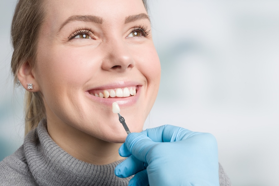 woman considering veneers vs lumineers