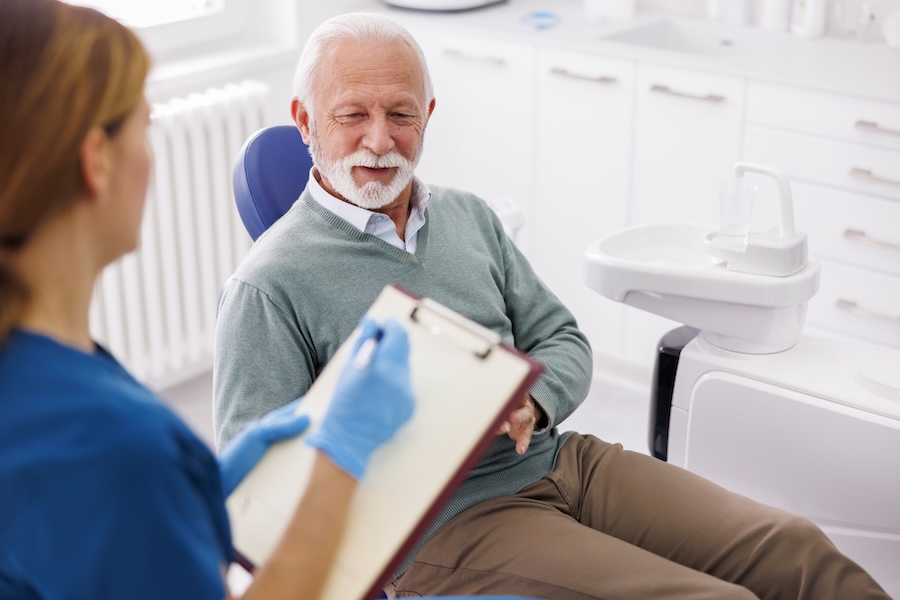 man talking with dental provider about how dental insurance works at the beginning of the year